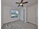 Cozy bedroom with a ceiling fan, plush carpet, and a closet with white doors at 36959 Highland Meadows Ct, Zephyrhills, FL 33542