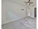 Cozy bedroom featuring soft carpeting, neutral walls, a ceiling fan, and adjacent bathroom access at 36959 Highland Meadows Ct, Zephyrhills, FL 33542