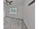 Neutral bedroom with soft carpeting, ceiling fan, and a window offering a view of the outdoors at 36959 Highland Meadows Ct, Zephyrhills, FL 33542