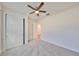 Comfortable bedroom featuring a ceiling fan, carpet flooring, and a closet with doors at 36959 Highland Meadows Ct, Zephyrhills, FL 33542