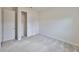 Light-filled bedroom features plush carpet and a closet with doors at 36959 Highland Meadows Ct, Zephyrhills, FL 33542
