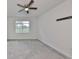 Neutral bedroom featuring plush carpeting, ceiling fan, and a window with a view at 36959 Highland Meadows Ct, Zephyrhills, FL 33542