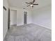 Bright and spacious bedroom featuring soft carpeting, an open doorway, and access to the bathroom at 36959 Highland Meadows Ct, Zephyrhills, FL 33542