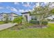Stylish single-Gathering home with an inviting front porch and lush landscaping at 36959 Highland Meadows Ct, Zephyrhills, FL 33542