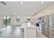 A modern kitchen showcases a central island, stainless steel appliances, and hardwood flooring at 36959 Highland Meadows Ct, Zephyrhills, FL 33542