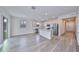 Open-concept kitchen features hardwood floors, stainless steel appliances, and a convenient center island at 36959 Highland Meadows Ct, Zephyrhills, FL 33542