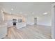 Bright kitchen boasts hardwood floors, stainless steel appliances, a central island, and an open layout at 36959 Highland Meadows Ct, Zephyrhills, FL 33542