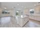 A bright, open kitchen features a large island, hardwood flooring, and ample natural light at 36959 Highland Meadows Ct, Zephyrhills, FL 33542