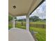 An open patio space with stone columns overlooking the beautiful green lawn and mature trees at 36959 Highland Meadows Ct, Zephyrhills, FL 33542
