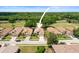 Aerial view of a single-story home with a two-car garage, manicured lawn, and golf course in the background at 3964 Silk Oak Ln, Palm Harbor, FL 34685