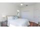 Comfortable bedroom with hardwood floors, a ceiling fan, and a double closet offering ample storage at 3964 Silk Oak Ln, Palm Harbor, FL 34685