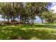 Scenic community park featuring lakeside views, lush green space, and a wooden deck for relaxing at 3964 Silk Oak Ln, Palm Harbor, FL 34685