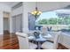 Dining area boasts wood floors, modern lighting, and a seamless view of outdoor space at 3964 Silk Oak Ln, Palm Harbor, FL 34685