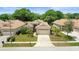 Charming single-story home with a two-car garage, well-manicured lawn, and mature landscaping at 3964 Silk Oak Ln, Palm Harbor, FL 34685