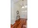 Elegant foyer with hardwood floors, a decorative table, and a view of the front doors at 3964 Silk Oak Ln, Palm Harbor, FL 34685