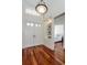 Inviting foyer with hardwood floors, a chandelier, and a glimpse into the bedroom at 3964 Silk Oak Ln, Palm Harbor, FL 34685