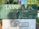 Lansbrook Golf Club sign with an alligator logo and text indicating it's open to the public at 3964 Silk Oak Ln, Palm Harbor, FL 34685
