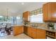 Well-appointed kitchen features granite countertops, stainless steel appliances, and wooden cabinetry at 3964 Silk Oak Ln, Palm Harbor, FL 34685