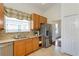 Kitchen featuring stainless steel appliances, granite countertops, tile flooring and plenty of storage space at 3964 Silk Oak Ln, Palm Harbor, FL 34685