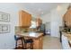 Bright kitchen features granite countertops, tile floors, wood cabinets and stainless steel appliances at 3964 Silk Oak Ln, Palm Harbor, FL 34685