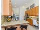Open kitchen with wooden cabinets, granite countertops, and stainless-steel appliances offers modern convenience at 3964 Silk Oak Ln, Palm Harbor, FL 34685
