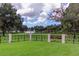 Scenic lakefront park with lush green grass, mature trees, and waterfront views for residents only at 3964 Silk Oak Ln, Palm Harbor, FL 34685