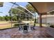 Covered lanai with tile flooring, outdoor seating, and views of a golf course at 3964 Silk Oak Ln, Palm Harbor, FL 34685