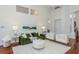 Open living room featuring bright natural light, high ceilings, wood floors, and elegant decor at 3964 Silk Oak Ln, Palm Harbor, FL 34685