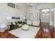 Spacious living room with tall ceilings, wood floors, and lots of natural light creates an inviting atmosphere at 3964 Silk Oak Ln, Palm Harbor, FL 34685