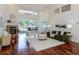 Bright living room with high ceilings, a fireplace, and a view of the outdoor screened lanai at 3964 Silk Oak Ln, Palm Harbor, FL 34685