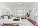 This bedroom boasts natural light, hardwood floors, neutral tones, and a cozy seating area at 3964 Silk Oak Ln, Palm Harbor, FL 34685
