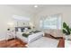 Serene main bedroom with wood floors, large windows, and plush decor for ultimate relaxation at 3964 Silk Oak Ln, Palm Harbor, FL 34685