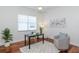 Inviting home office featuring hardwood floors, a comfortable chair, and plenty of natural light at 3964 Silk Oak Ln, Palm Harbor, FL 34685