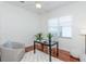 Bright office space featuring a desk, chair, accent chair, and hardwood floors at 3964 Silk Oak Ln, Palm Harbor, FL 34685