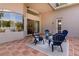Enclosed patio with terracotta tile flooring and four blue chairs surrounding a glass table on a neutral rug at 3964 Silk Oak Ln, Palm Harbor, FL 34685