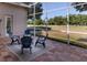 Relaxing screened in porch with four chairs and a golf course view at 3964 Silk Oak Ln, Palm Harbor, FL 34685