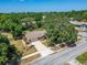 Aerial view of a well-maintained home with mature trees and inviting curb appeal at 402 Merlin Ct, Brandon, FL 33510