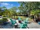 Backyard features a fire pit, chairs and lots of greenery at 402 Merlin Ct, Brandon, FL 33510