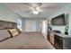 Comfortable bedroom featuring a large bed, ceiling fan, closet, and storage at 402 Merlin Ct, Brandon, FL 33510