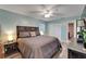 Inviting bedroom featuring a comfortable bed, ceiling fan, and ample closet space at 402 Merlin Ct, Brandon, FL 33510
