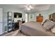Serene bedroom featuring a ceiling fan and an eclectic mix of furniture and décor at 402 Merlin Ct, Brandon, FL 33510