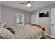 Bedroom with ceiling fan, window, and a wall-mounted television at 402 Merlin Ct, Brandon, FL 33510