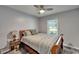 Cozy bedroom with ceiling fan, wooden sleigh bed, and natural light from the window at 402 Merlin Ct, Brandon, FL 33510