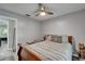 Bedroom features a wooden bed frame, ceiling fan, and a tranquil atmosphere at 402 Merlin Ct, Brandon, FL 33510