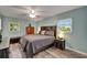 Comfortable bedroom featuring a ceiling fan, windows, and a serene color palette at 402 Merlin Ct, Brandon, FL 33510