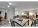 Open-concept dining area flowing into a living room with lots of natural light and wood floors at 402 Merlin Ct, Brandon, FL 33510