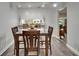 Dining room with table and chairs with view into the living room and outdoor bar at 402 Merlin Ct, Brandon, FL 33510
