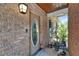 Charming front entry featuring a wood door with oval glass, wood ceiling and lovely plants at 402 Merlin Ct, Brandon, FL 33510