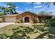Charming brick home features an arched doorway, mature landscaping and a two-car garage at 402 Merlin Ct, Brandon, FL 33510