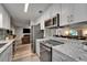 Open-concept kitchen showcases stainless steel appliances, granite countertops, and seamless flow to the living area at 402 Merlin Ct, Brandon, FL 33510